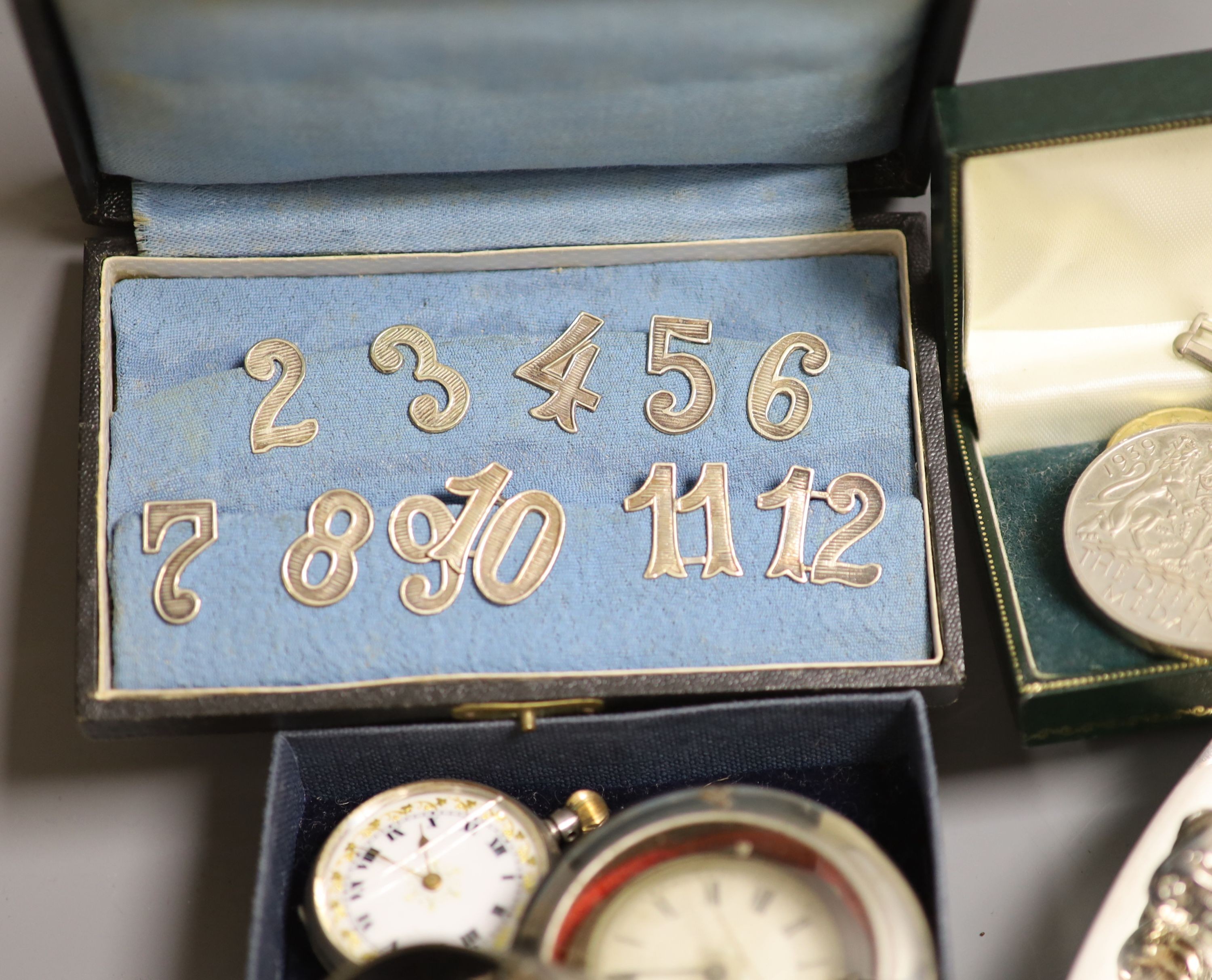 A plated silver stand, a fob watch, coins etc.